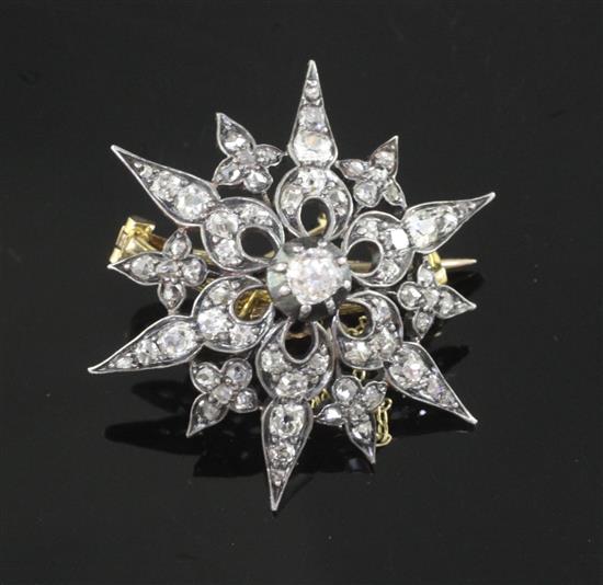 A Victorian gold, silver and diamond set pierced starburst brooch, 33mm.